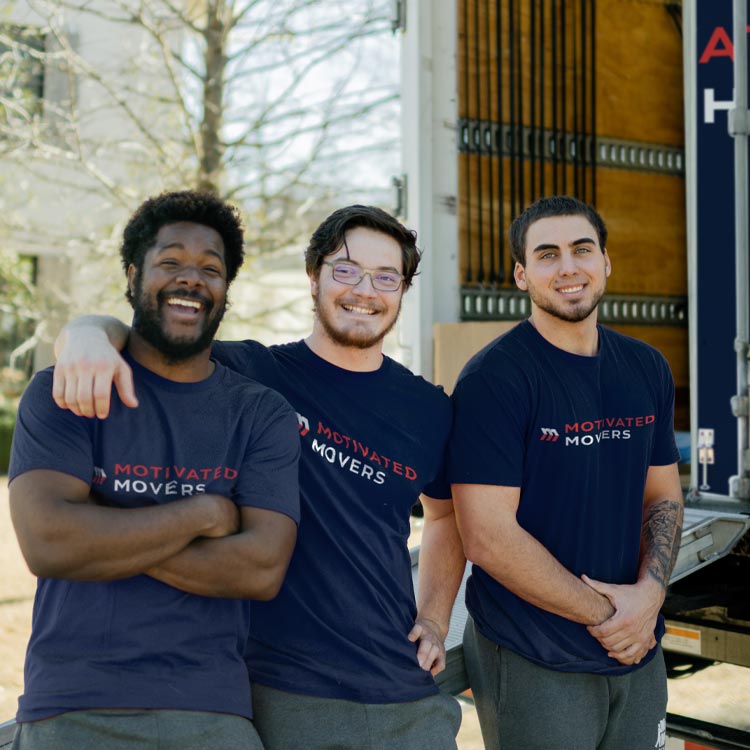 A friendly Motivated Movers crew poses together, symbolizing teamwork and reliable moving services.