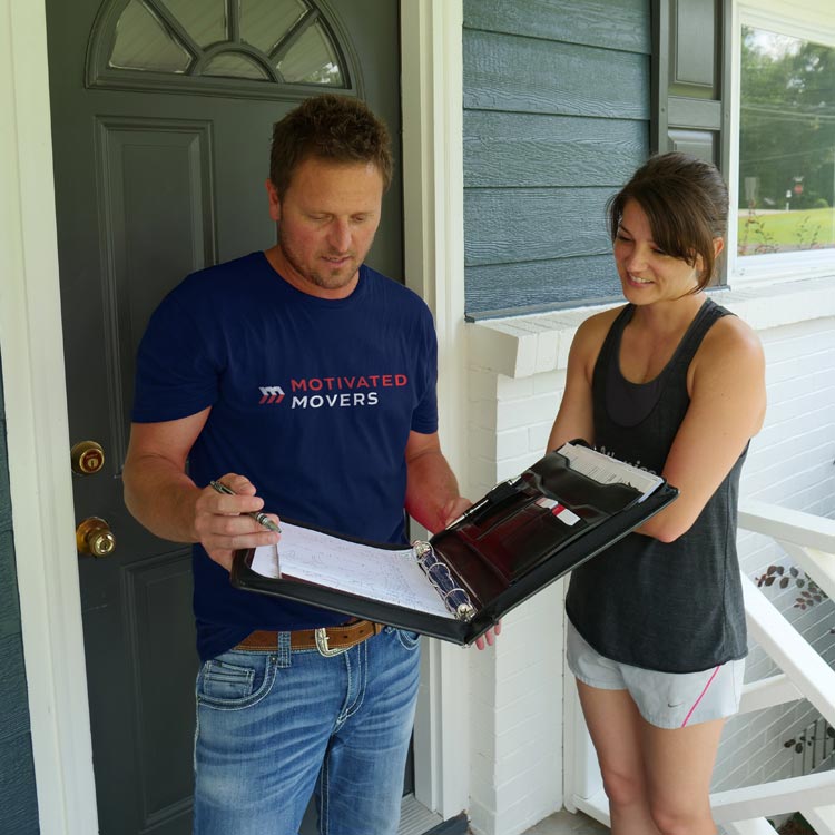 A Motivated Movers specialist reviews moving details with a homeowner, offering personalized moving consultation.