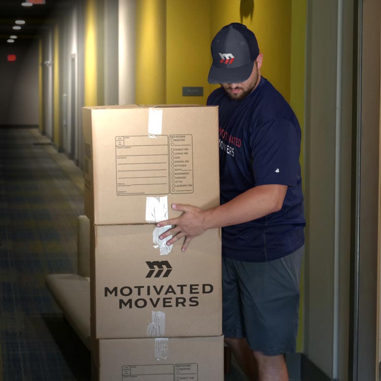 Motivated Movers worker carefully checks an employee inventory, ensuring accurate and organized relocation services.